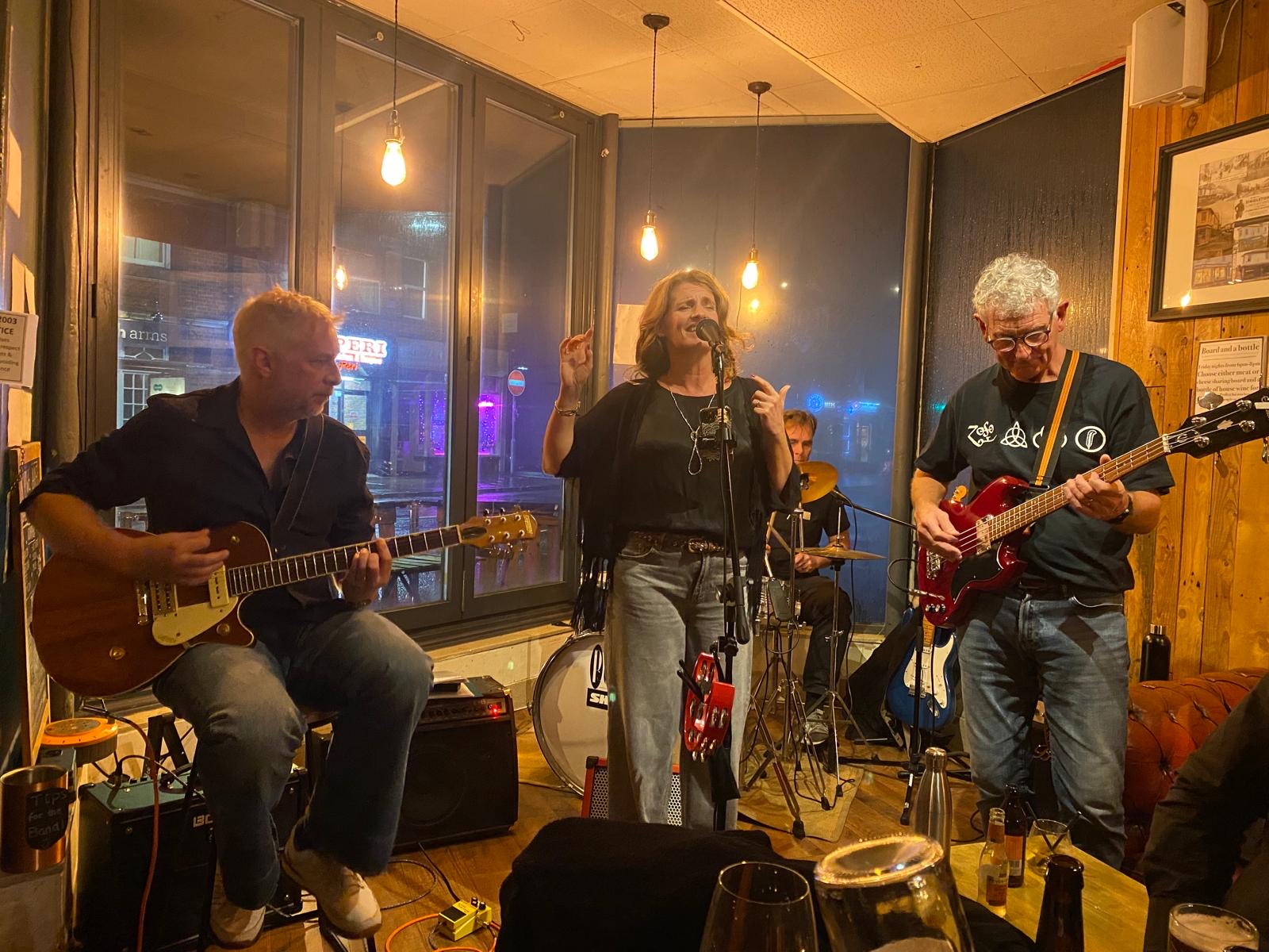 Shenanigans playing an evening gig with guitar, bass and drums