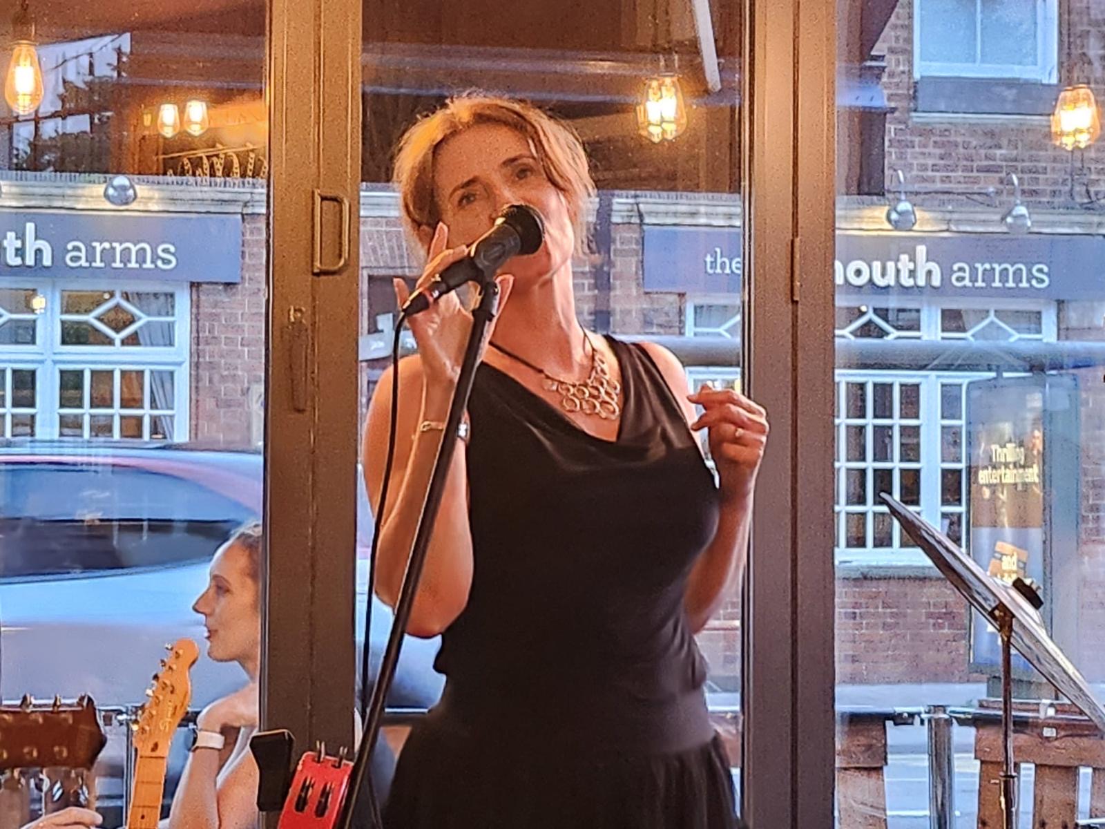The Shenanigans singer performing at the microphone