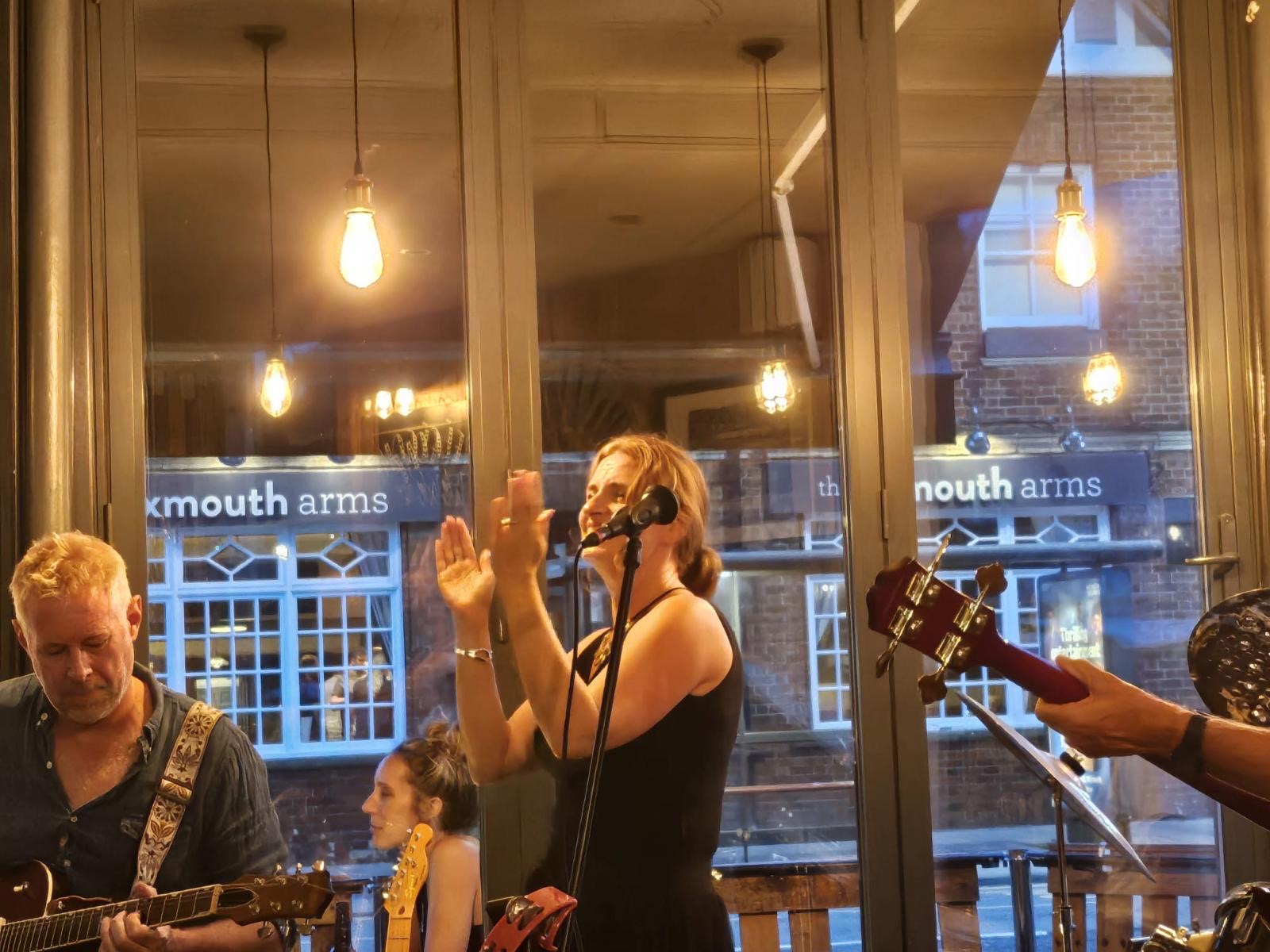 The singer clapping along with the band